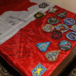 canadian flag with wishes and mottos by different battalions of the Ukrainian Armed Forces written on it and battalion chevrons attached